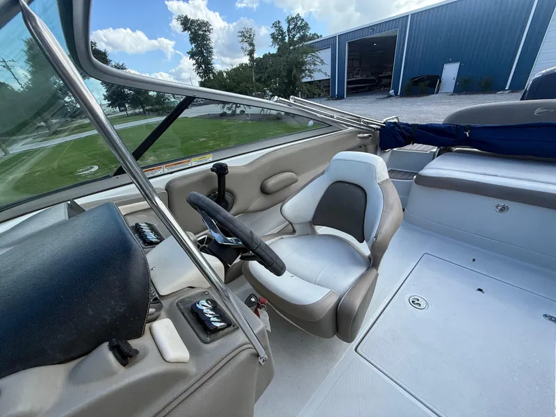 Slide: The Image of 2022 Crownline Eclipse E215 XS boat interior with steering wheel and seating. - 18