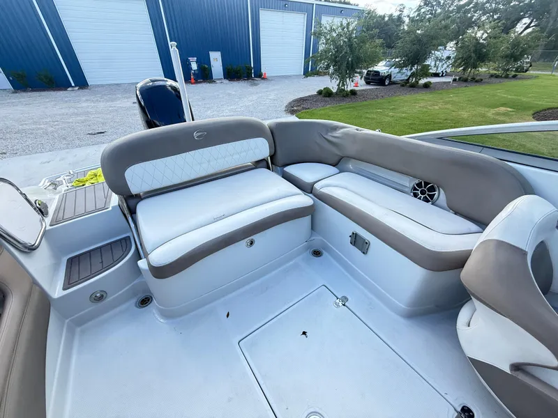 Slide: The Image of 2022 Crownline Eclipse E215 XS boat interior with cushioned seating and storage compartments. - 21