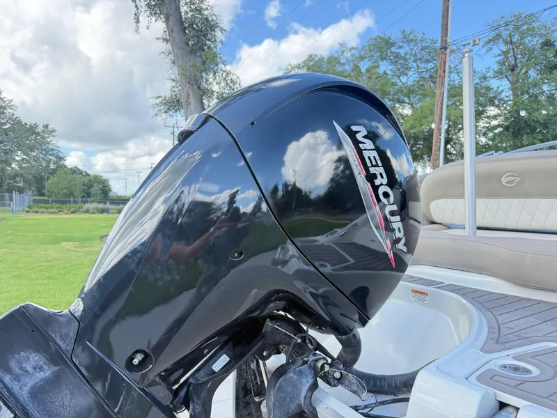 Slide: The Image of 2022 Crownline Eclipse E215 XS with Mercury outboard motor, parked outdoors. - 24