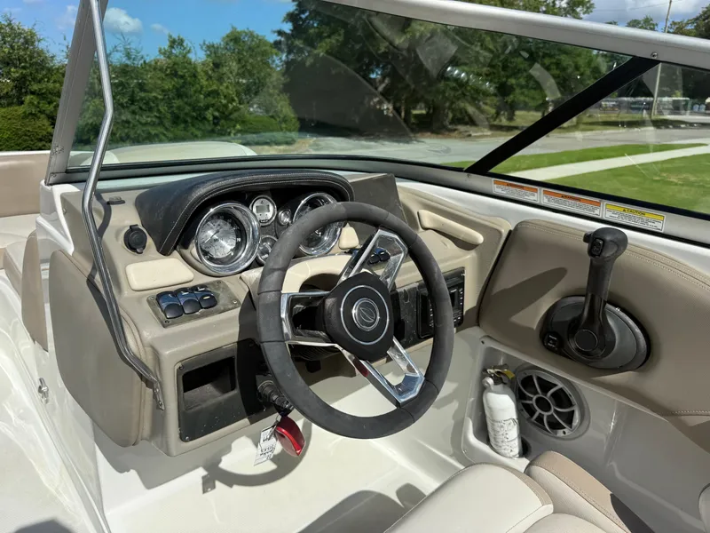 Slide: The Image of 2022 Crownline Eclipse E215 XS boat dashboard with steering wheel and controls. - 7