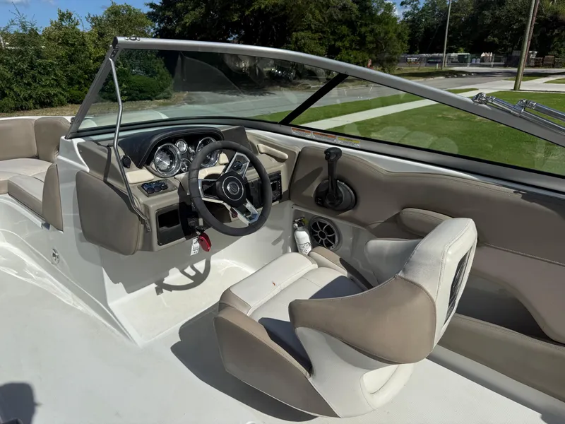 Slide: The Image of 2022 Crownline Eclipse E215 XS boat interior with steering wheel and dashboard controls. - 8