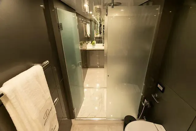 Slide: The Image of Luxurious bathroom in Schaefer 770 yacht, featuring modern fixtures and frosted glass shower, 2026 model. - 18