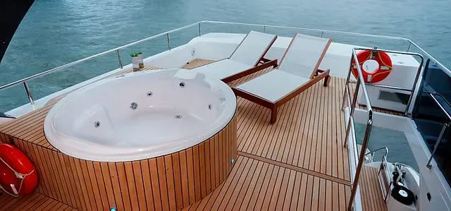 Slide: The Image of Luxurious Schaefer 770 yacht deck with jacuzzi and sun loungers, 2026 model. - 28
