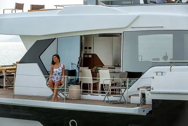 Slide: The Image of Luxury yacht Schaefer 770, 2026 model, with a woman enjoying the deck. - 6