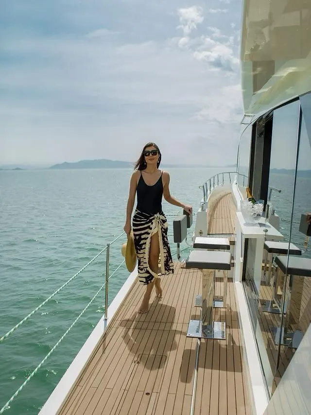 Slide: The Image of Woman walking on Schaefer 770 yacht deck, 2026 model, ocean view. - 7