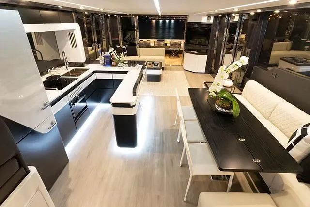 Slide: The Image of Luxurious interior of 2026 Schaefer 770 yacht with modern kitchen and elegant dining area. - 8