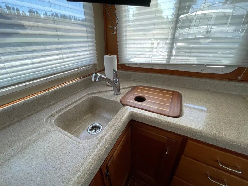 Slide: The Image of 2006 American Tug 34 kitchen with sink, faucet, and cutting board. - 12