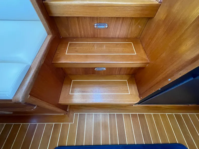 Slide: The Image of Wooden interior steps on a 2006 American Tug 34 boat, featuring elegant design and craftsmanship. - 13