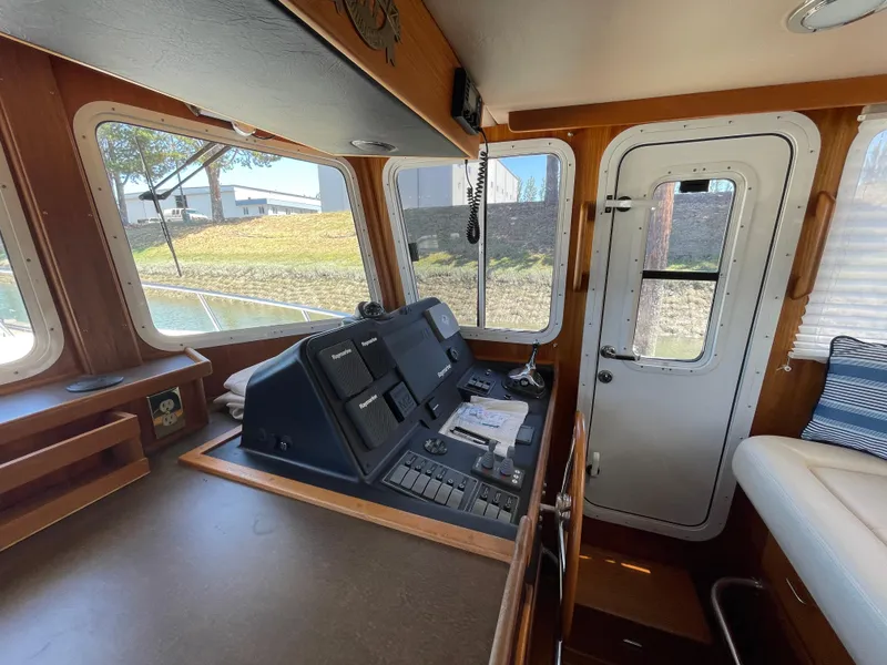 Slide: The Image of Interior helm of 2006 American Tug 34 with control panel and windows. - 16