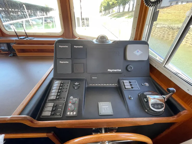 Slide: The Image of 2006 American Tug 34 helm with Raymarine navigation equipment and controls. - 17