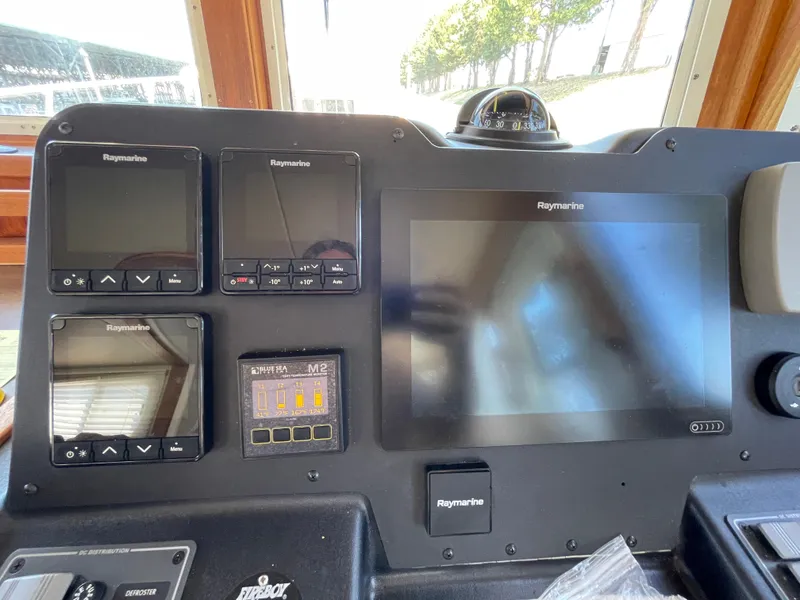 Slide: The Image of Control panel of a 2006 American Tug 34 with Raymarine navigation displays. - 18