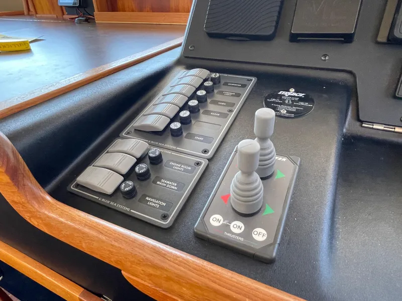 Slide: The Image of Control panel of a 2006 American Tug 34 with switches and joysticks. - 20