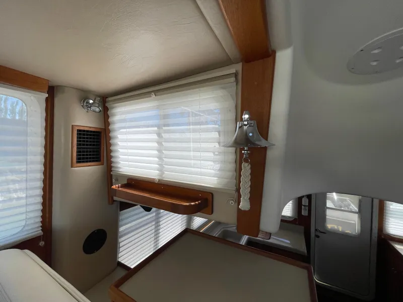 Slide: The Image of Interior of 2006 American Tug 34 with wood accents and window blinds. - 21