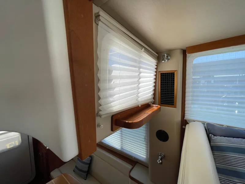 Slide: The Image of Interior of 2006 American Tug 34 with window blinds and wooden accents. - 22