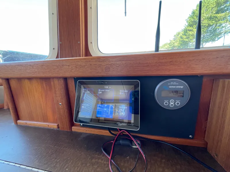 Slide: The Image of Control panel on 2006 American Tug 34 boat, featuring Victron Energy display. - 25