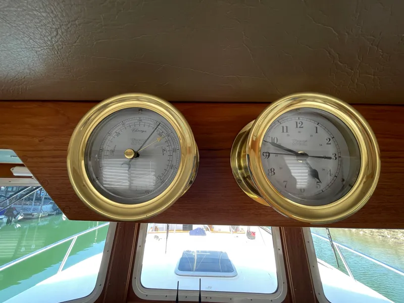 Slide: The Image of Brass barometer and clock on 2006 American Tug 34 boat dashboard. - 26