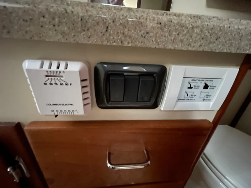 Slide: The Image of Control panel and switches in a 2006 American Tug 34 boat interior. - 27