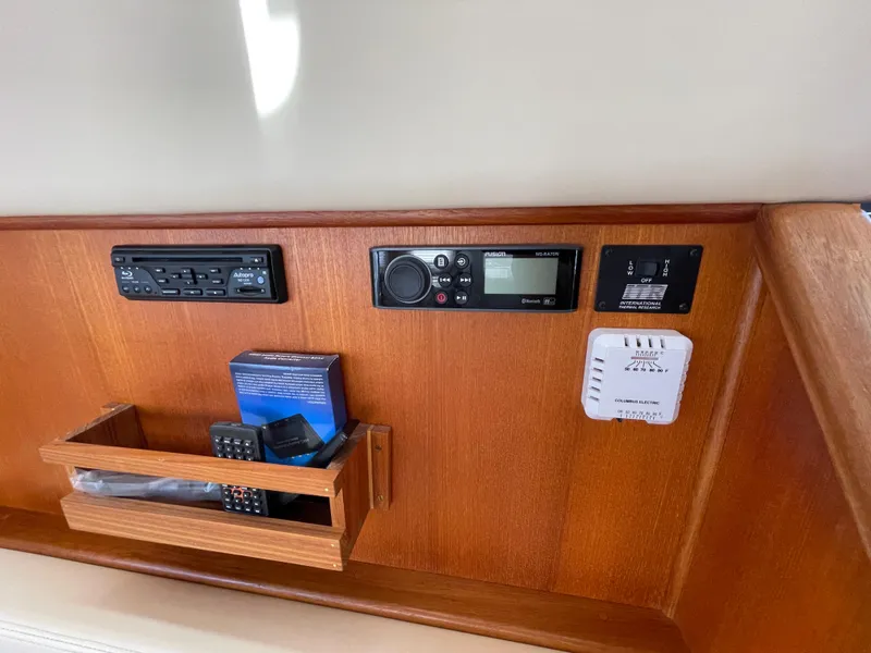 Slide: The Image of Control panel of a 2006 American Tug 34 with audio system and storage compartment. - 30