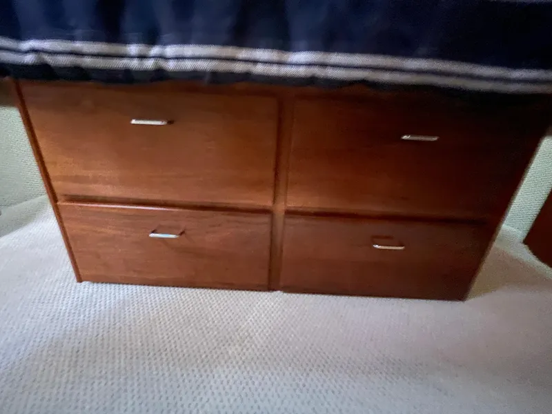 Slide: The Image of Wooden drawers under a bed in a 2006 American Tug 34 boat interior. - 40