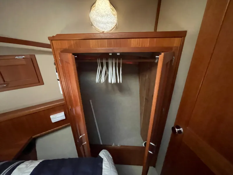 Slide: The Image of Open wooden closet with hangers inside American Tug 34, 2006 model. - 42