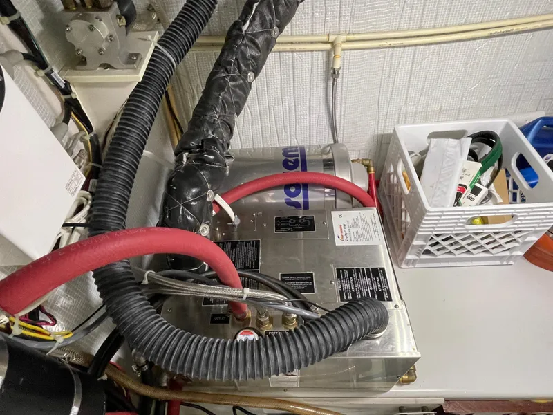 Slide: The Image of Engine room of a 2006 American Tug 34 with mechanical components and storage basket. - 54