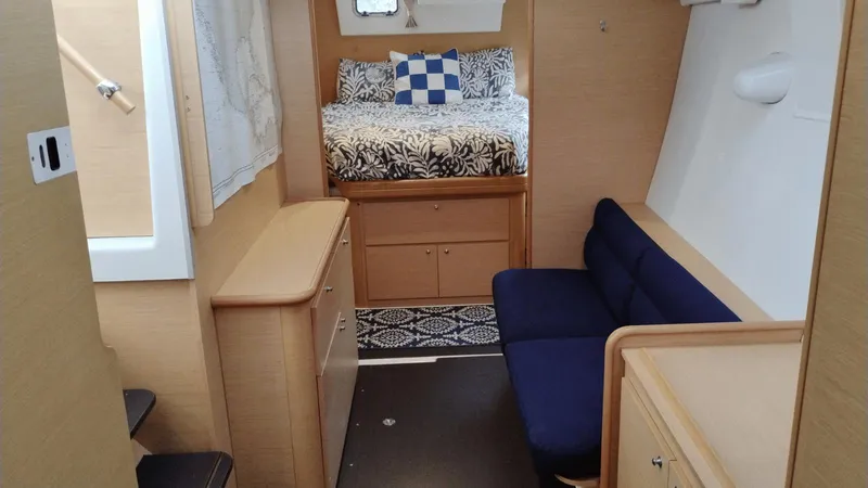 Slide: The Image of Interior of a 2008 Lagoon 420 yacht with cozy bed and seating area. - 12