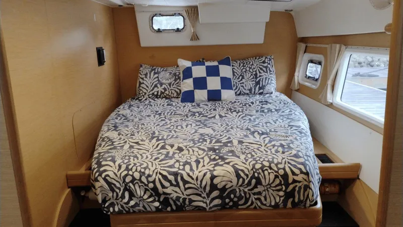 Slide: The Image of Cozy bedroom in 2008 Lagoon 420 yacht with floral bedding and nautical decor. - 13
