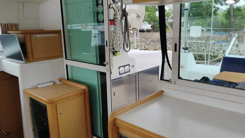 Slide: The Image of Interior view of 2008 Lagoon 420 catamaran with modern kitchen and outdoor access. - 19