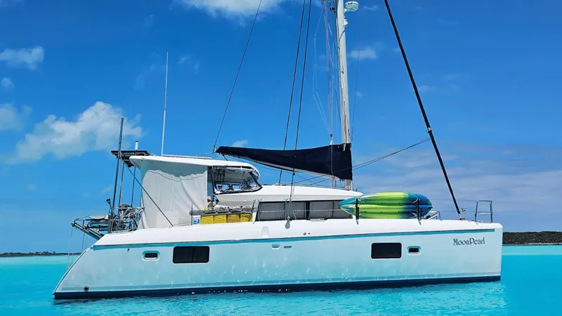 Slide: The Image of 2008 Lagoon 420 catamaran sailing on clear blue waters under a bright sky. - 2