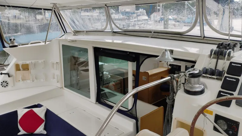Slide: The Image of Interior view of 2008 Lagoon 420 yacht cockpit with seating and navigation controls. - 23