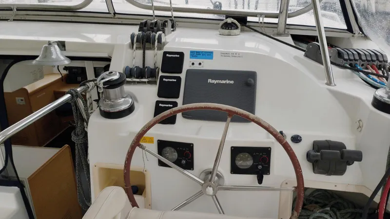 Slide: The Image of Steering wheel and controls of a 2008 Lagoon 420 catamaran. - 24