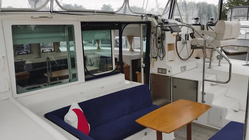 Slide: The Image of 2008 Lagoon 420 yacht interior with seating, table, and helm station. - 25