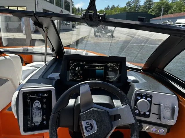 Slide: The Image of 2023 Malibu 21 LX boat dashboard with modern controls and digital displays. - 13