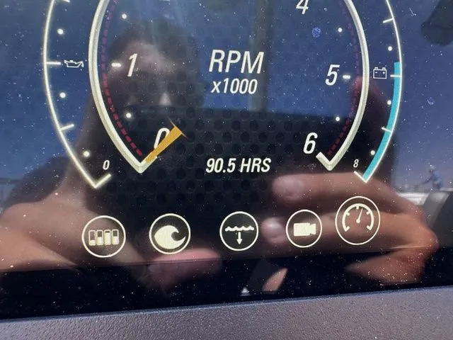 Slide: The Image of 2023 Malibu 21 LX dashboard showing 90.5 hours and RPM gauge. - 14