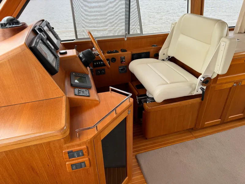 Slide: The Image of 2009 Grand Banks 45 Eastbay SX helm with wooden dashboard and white captain's chair. - 16