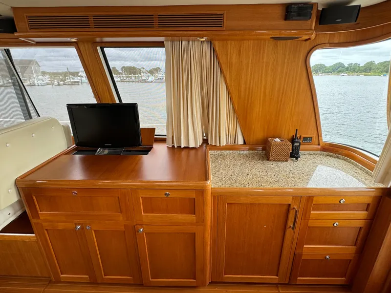 Slide: The Image of Interior of 2009 Grand Banks 45 Eastbay SX yacht with wooden cabinetry and window view. - 18