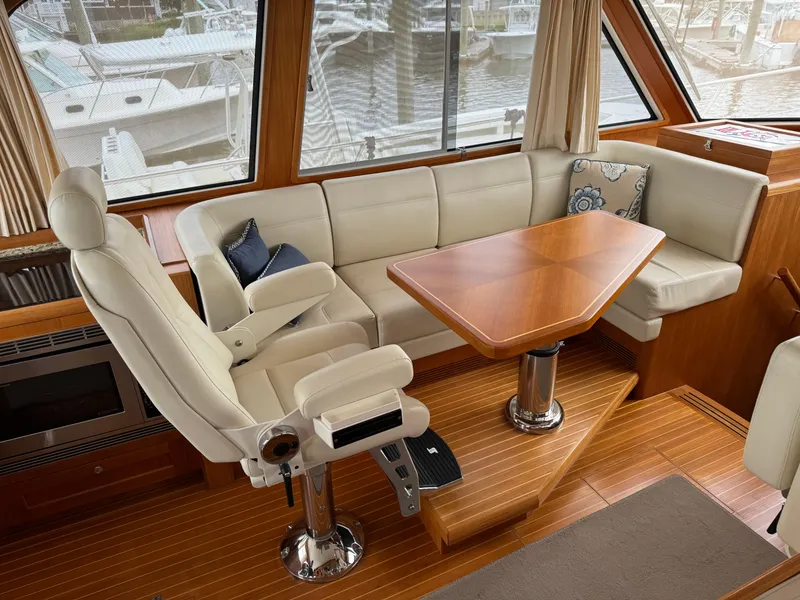 Slide: The Image of Luxurious 2009 Grand Banks 45 Eastbay SX yacht interior with plush seating and wooden table. - 25