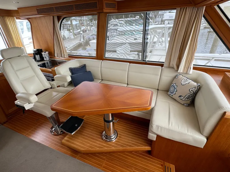 Slide: The Image of Luxurious interior of 2009 Grand Banks 45 Eastbay SX yacht with leather seating and wooden table. - 26