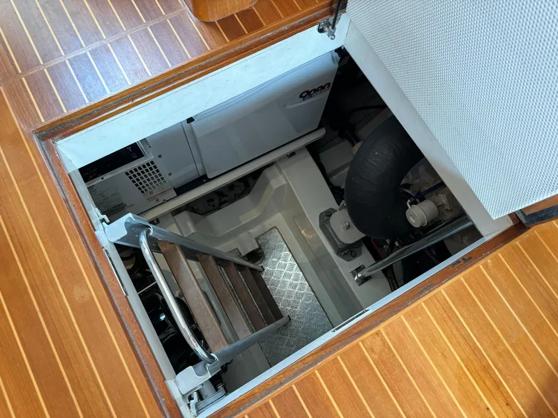Slide: The Image of Engine room access hatch on 2009 Grand Banks 45 Eastbay SX yacht with wooden flooring. - 49