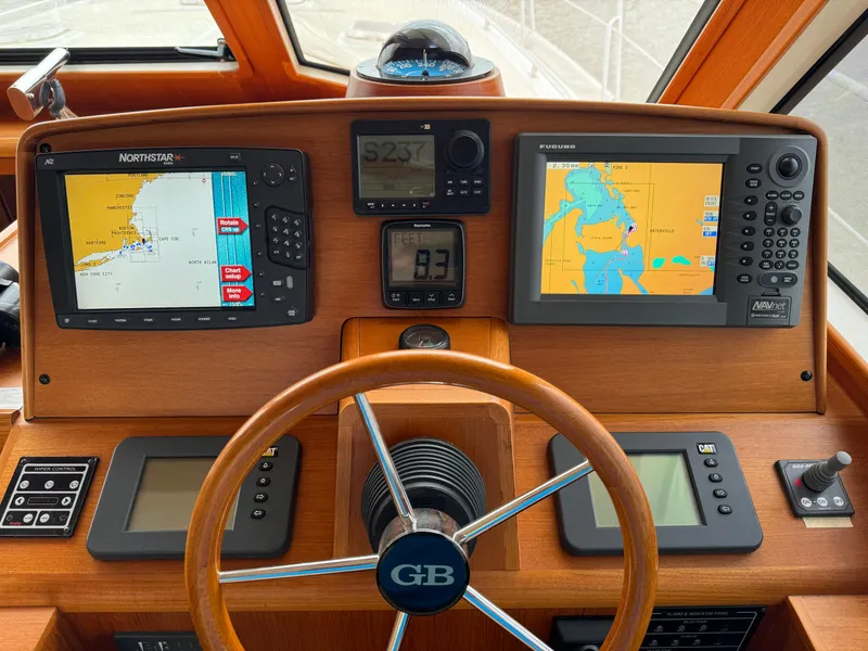 Slide: The Image of Helm of 2009 Grand Banks 45 Eastbay SX with navigation displays and controls. - 8