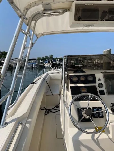 Slide: The Image of 1990 Donzi F-33 boat interior with steering wheel and control panel at marina. - 12