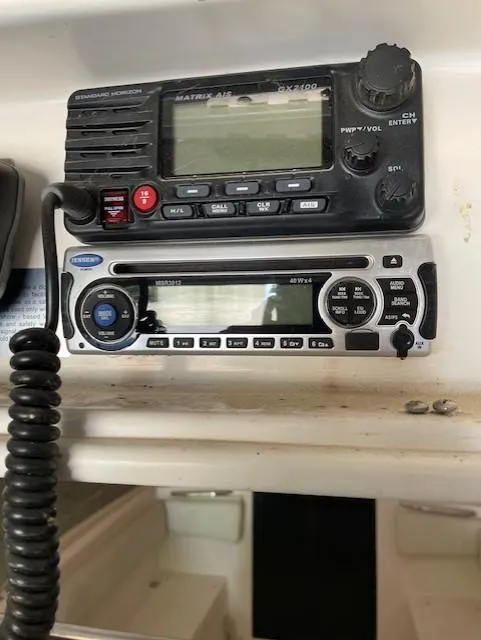 Slide: The Image of 1990 Donzi F-33 boat radio and communication equipment, featuring a Standard Horizon marine radio. - 14