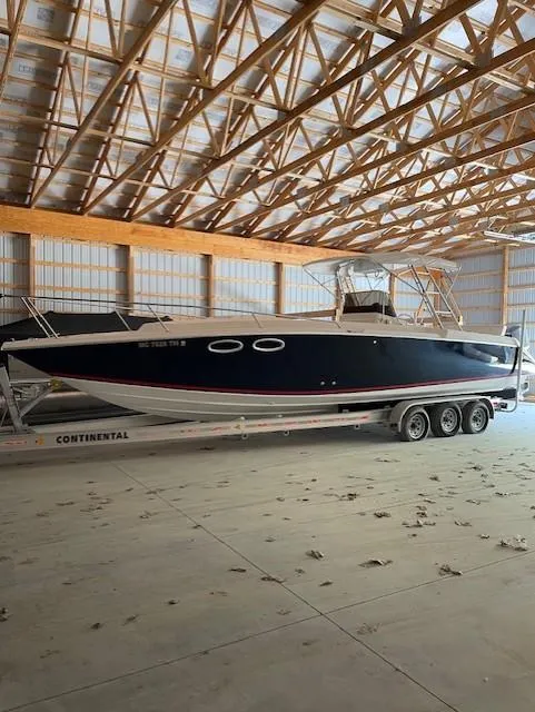 Slide: The Image of 1990 Donzi F-33 boat on trailer in a wooden storage facility. - 3