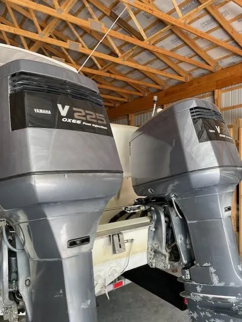 Slide: The Image of Twin Yamaha V225 outboard engines on a 1990 Donzi F-33 boat in a wooden garage. - 5