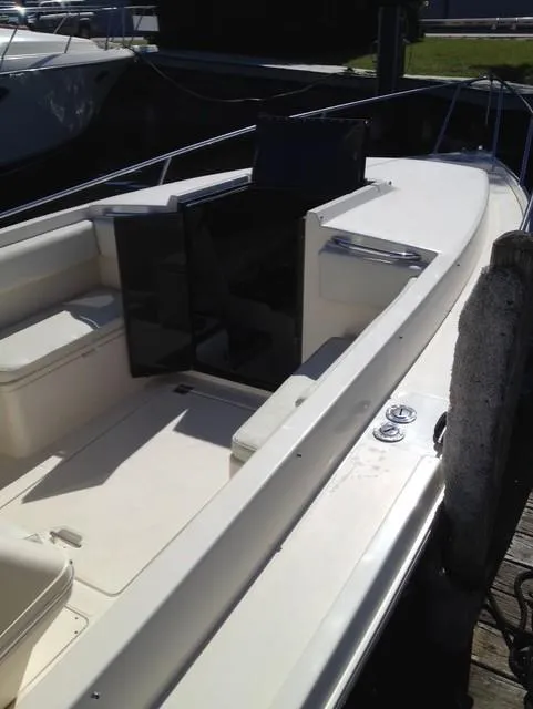 Slide: The Image of 1990 Donzi F-33 boat docked, featuring open deck and seating area. - 6