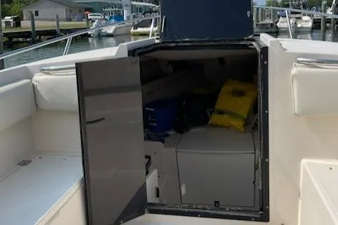 Slide: The Image of 1990 Donzi F-33 boat interior storage compartment with open door, docked at marina. - 7