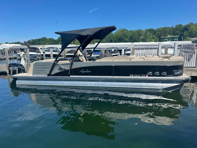 Slide: The Image of 2018 Avalon Catalina Platinum Entertainer 27' pontoon boat docked on a sunny day. - 0