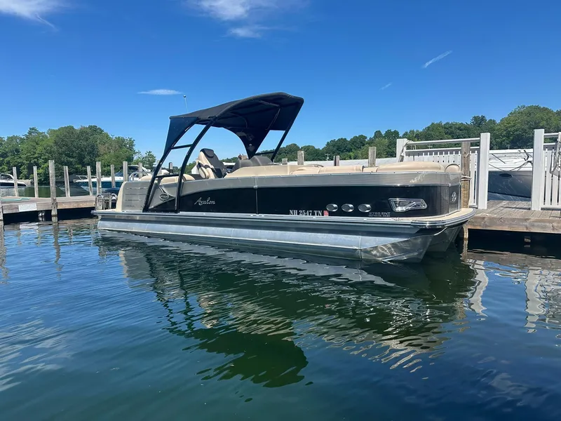 Slide: The Image of 2018 Avalon Catalina Platinum Entertainer pontoon boat docked on a sunny day. - 1