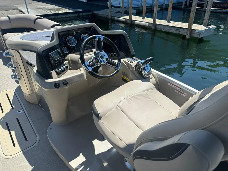 Slide: The Image of 2018 Avalon Catalina Platinum Entertainer boat cockpit with steering wheel and controls. - 11
