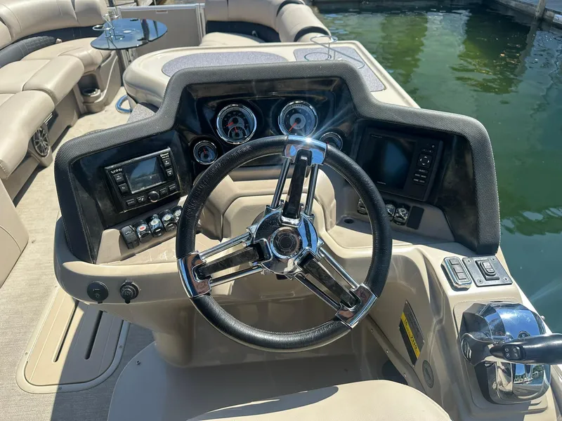 Slide: The Image of Steering console of 2018 Avalon Catalina Platinum Entertainer boat, featuring modern controls and gauges. - 12